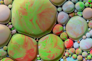 Macro photography of colorful bubbles in some fluids producing vibrant fleeting microworlds that are eternalized in a picture.
