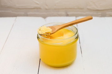 Ghee butter in a jar on white background
