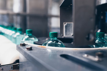 Bottling plant - Water bottling line for processing and bottling pure spring water into small bottles. Selective focus.