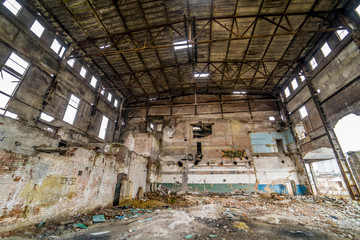 Abandoned Industrial building. Old factory ruin and broken windows.