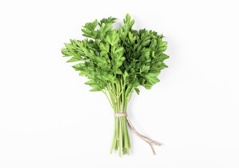 Parsley bunch isolated on white background. Flat lay. Top view. Minimal food concept.