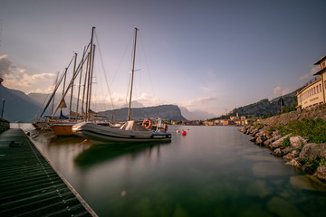 Sailing, boats, in a harbor. Lago di garda, garda lake, torbole, boat on a lake in the evening sun....