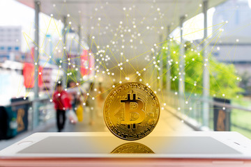 Golden digital bitcoins Currency stand on smartphone Digital Network and society background in bangkok city