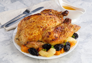 Roast Turkey, chicken, decorated with pumpkins, prunes, apples. thanksgiving day. slow food