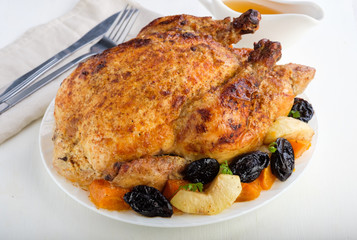 Roast Turkey, chicken, decorated with pumpkins, prunes, apples. thanksgiving day. slow food