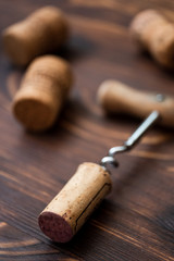 Fototapeta na wymiar Corkscrew and corks on a wooden background.