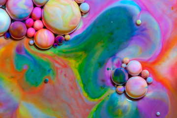 Macro photography of colorful bubbles in some fluids producing vibrant fleeting microworlds that are eternalized in a picture.