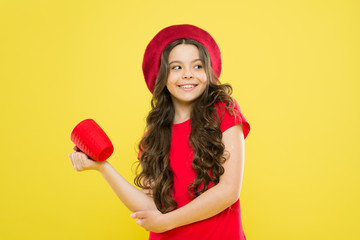 kid drink tea. childhood. hairdresser salon. beauty and fashion. parisian child on yellow background. happy girl with long curly hair in beret. little girl in french style hat hold tea cup. Tea time