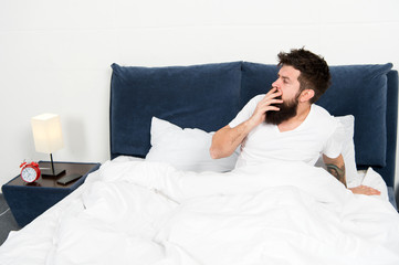 asleep and awake. bearded man hipster sleep in morning. mature male with beard in pajama on bed. brutal sleepy man in bedroom. energy and tiredness. Sleeping at home. man yawning after sleeping