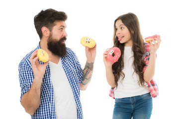 Happy family. Let me help you. little child love her dad. father and daughter eating donut. having fun together. fathers day. childrens day. family bonds. happy little girl with father. donut cooking