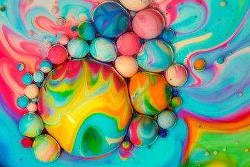 Fototapeta na wymiar Macro photography of colorful bubbles in some fluids producing vibrant fleeting microworlds that are eternalized in a picture.