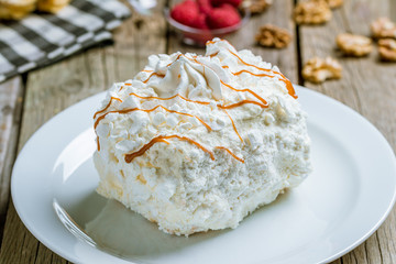 Big meringue on plate on board