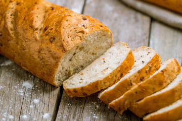 white bread with bran on wooden background