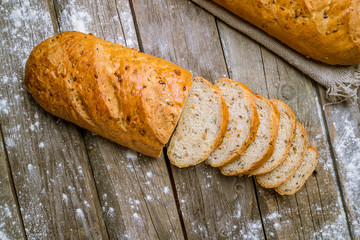 white bread with bran on wooden background
