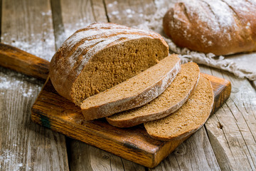 round black bread on wooden background