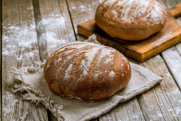 round black bread on wooden background