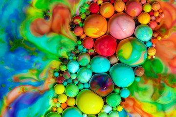Macro photography of colorful bubbles in some fluids producing vibrant fleeting microworlds that are eternalized in a picture.