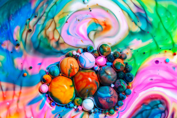 Macro photography of colorful bubbles in some fluids producing vibrant fleeting microworlds that are eternalized in a picture.