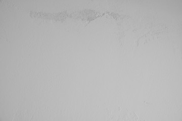 graue verputzte Betonwand mit alten rauen Stellen im oberen Bildbereich. Hintergrund, Textur, gestalterisches, abstraktes Element, Kunst im Industrial Style,  Tapete, Steinwand, Betonwand, Zement