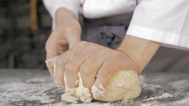 Male hands making dough for pizza