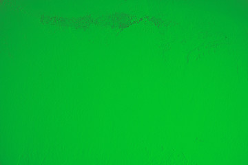 Hell, grün, Pastell, Betonwand mit schmutziger, alter, rauer Struktur im oberen Teil des Bildes. Steinwand, Zementwand im Industrial Style als Hintergrund, Tapete, Gestaltungselement, Kunst