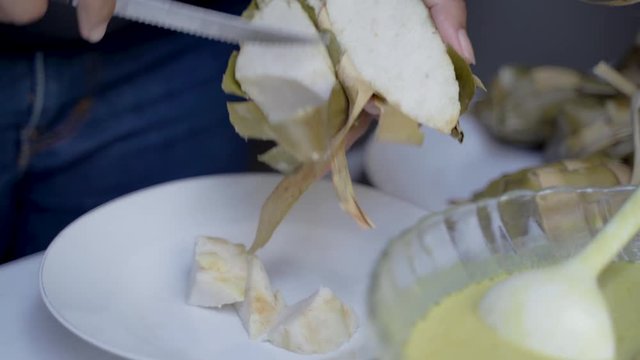 hand preparing rice cake or ketupat for eid mubarak celebration