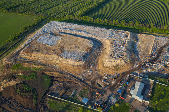 Aerial view of city dump or landfill. Pile of plastic trash, food waste and other garbage. Pollution concept
