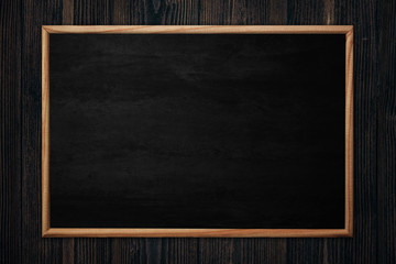 Abstract blackboard or chalkboard with frame on wooden background.
