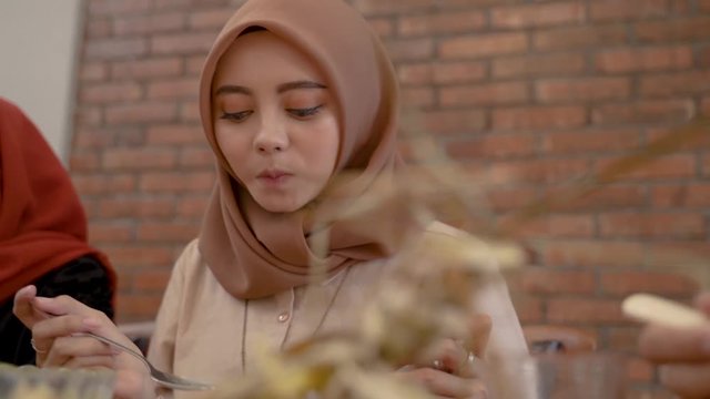 beautiful young woman in scarf eat after fasting all day