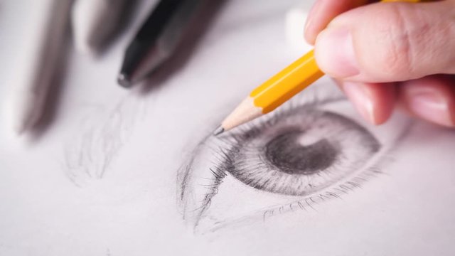 Artist drawing eyelash with a wooden graphite pencil. 4k.