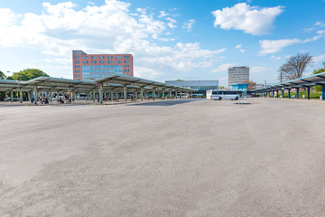 Bus on parking lot near platforms with shelters at bus station © lubos K