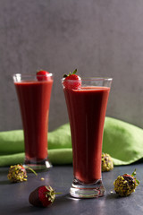 Chocolate strawberry smoothie and chocolate covered berries with chopped pistachios. Healthy drink