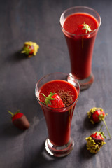 Chocolate strawberry smoothie and chocolate covered berries with chopped pistachios. Healthy drink