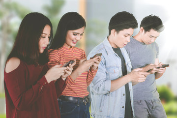 Four people browses internet with smartphones