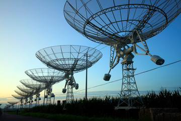 The silhouette of a radio telescope