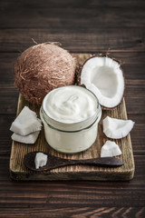 Coconut cream in a glass jar with fresh coconut