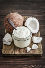 Coconut cream in a glass jar with fresh coconut