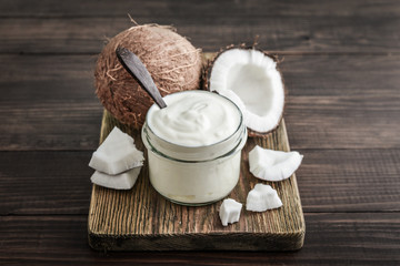 Coconut cream in a glass jar with fresh coconut