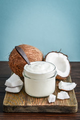 Coconut cream in a glass jar with fresh coconut