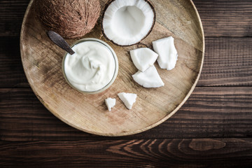 Coconut cream in a glass jar with fresh coconut