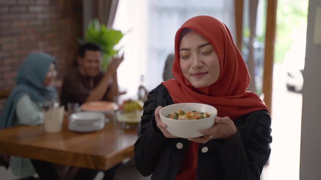 beautiful muslim woman with food served for family and friend for dinner together