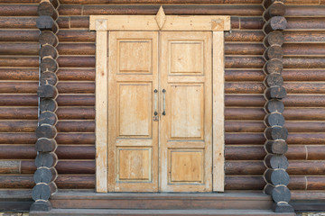 Old shabby wooden door in a traditional Russian hut.