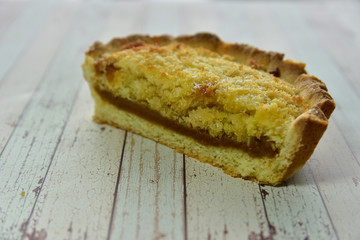 Steps of cooking a gluten free coconut and caramel pie on a wooden background