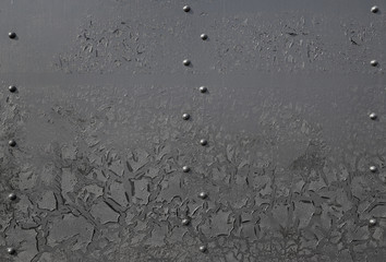 Black metal surface with rivets and oil dirt. Abstract industrial background