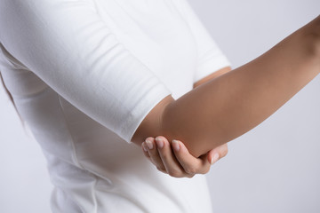 Closeup female's elbow. Arm pain and injury. Health care and medical concept.