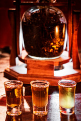 shot glasses with brandy whisky and rum in cozy bar