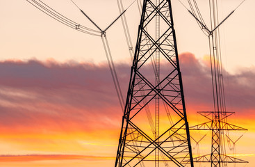High voltage electric pole and transmission lines in the evening. Electricity pylons at sunset....