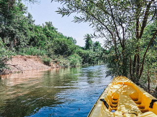 adventure activities kayaking in a river with mountain view and good weather at Thailand 