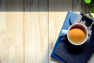 Top view cup of coffee on books with copy space.