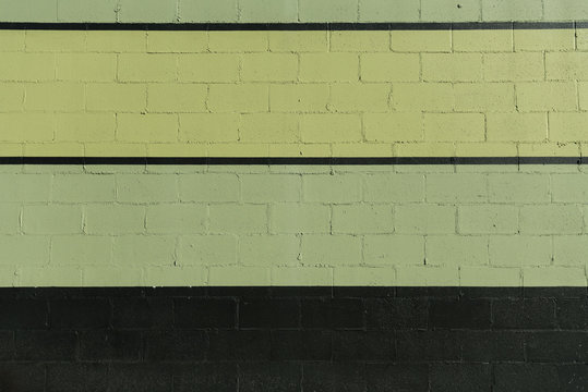 Green And Black Stripes On Cinder Block Wall